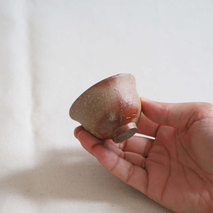 備前焼緋襷茶杯を手で持っている