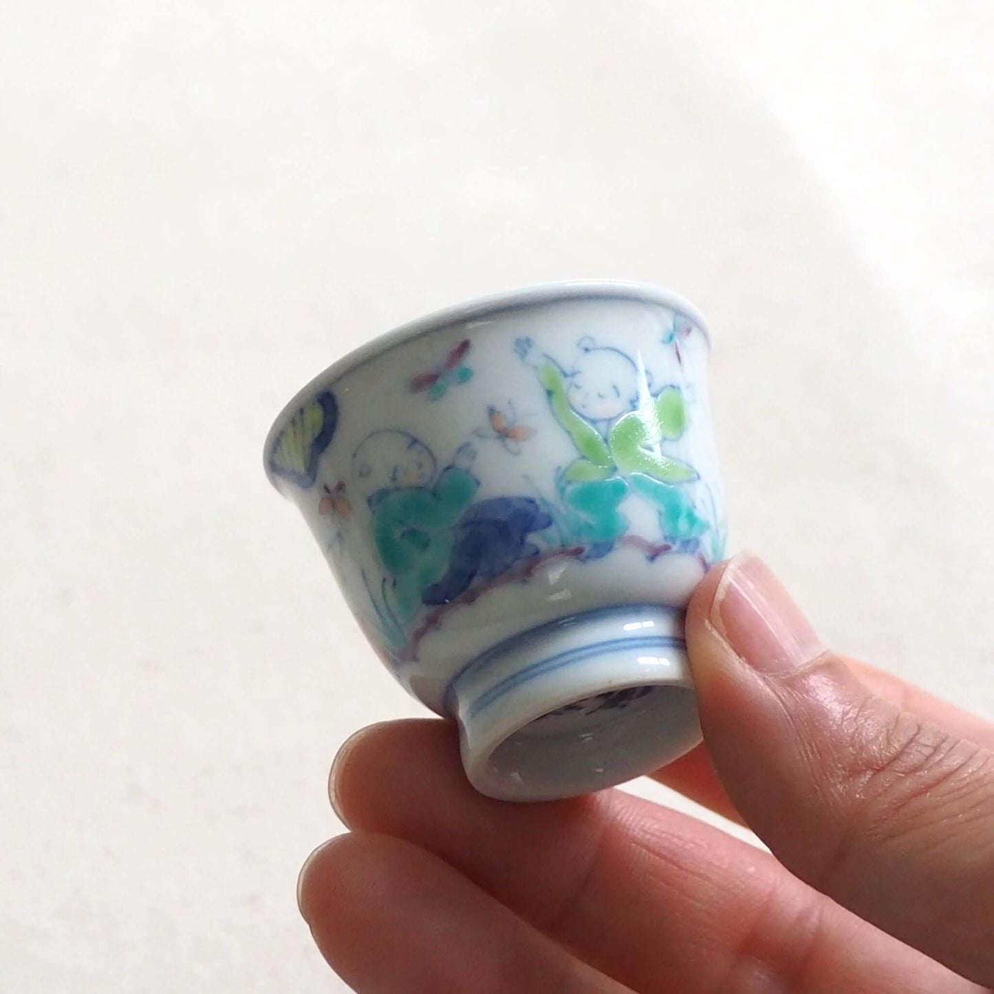 京焼 昭阿弥作 淡彩唐子煎茶杯 手描き唐子文様 伝統工芸 京都陶器　手で持っている