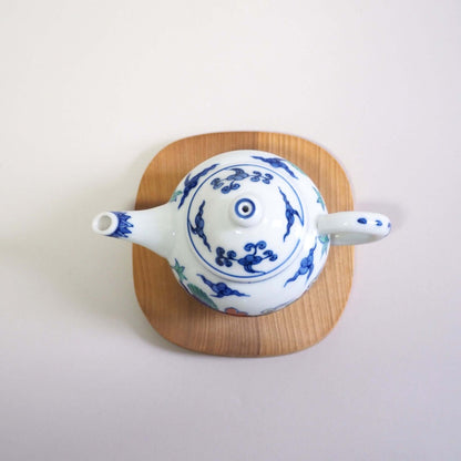 A Kyo-yaki teapot with a colorful dragon design by Shoami, viewed from directly above.