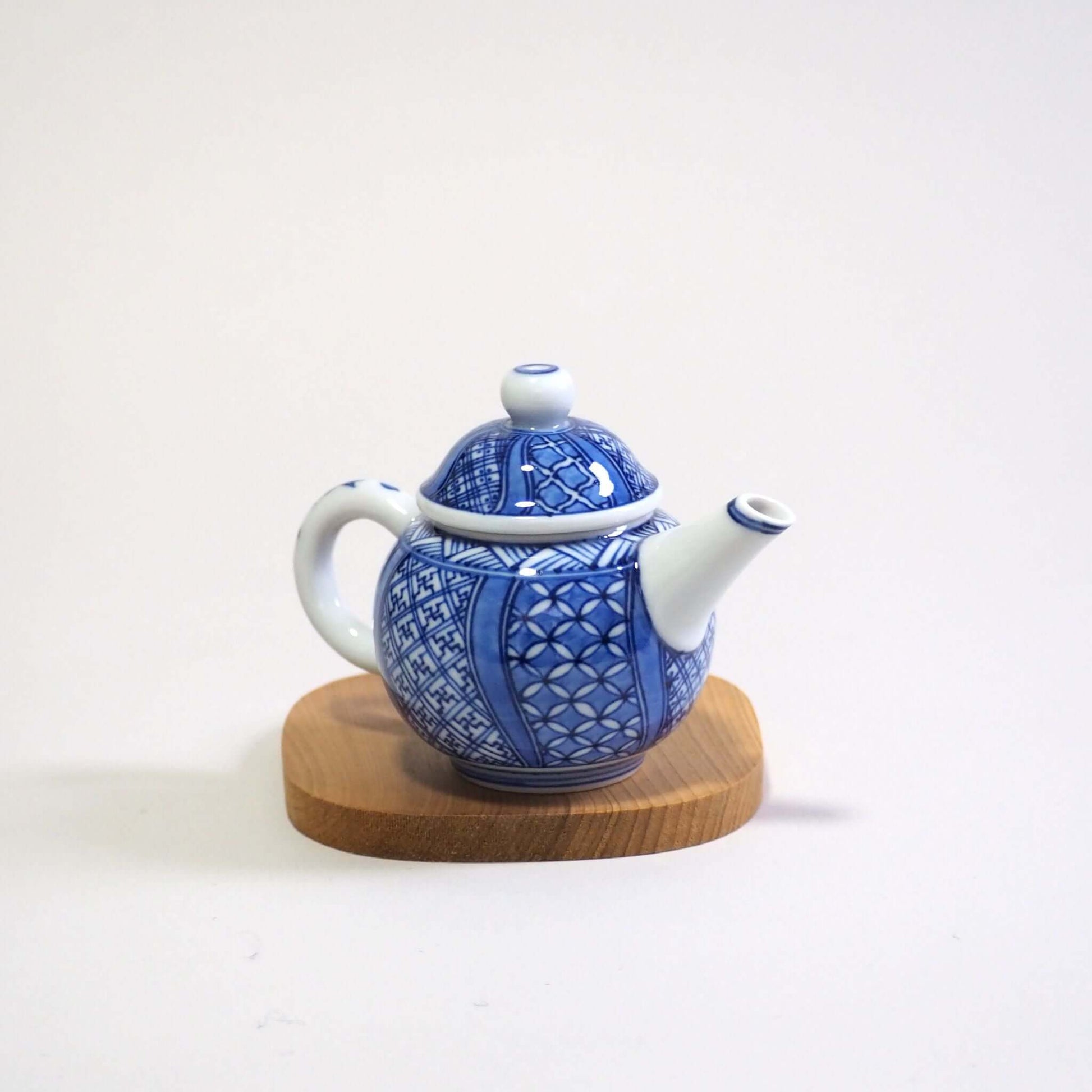 Looking at a Kyo-yaki Shoami underglaze blue Shōzui teapot from a diagonal top view.
