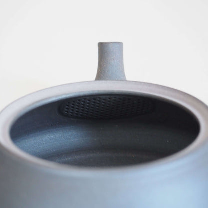 Tea strainer inside the black triangular flat teapot by Tokoname ware potter Tokuta Fujita