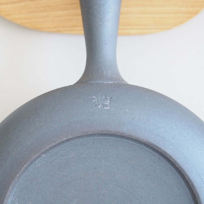 The potter's seal on the bottom of Tokoname ware potter Tokuta Fujita's black triangular flat teapot