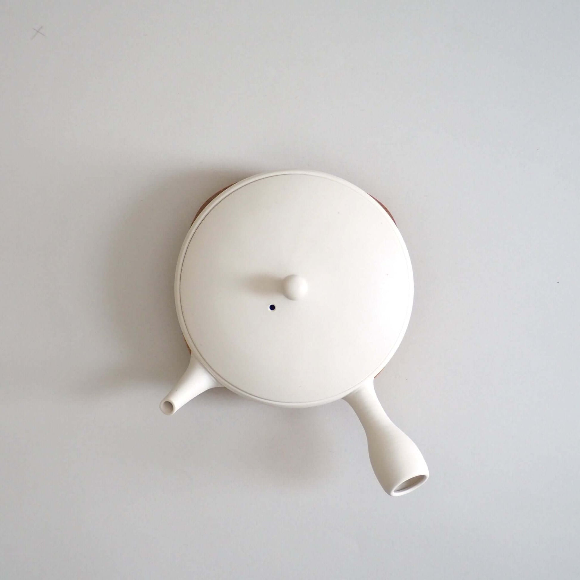 Tokoname ware white flat teapot, viewed from above — soft white appearance achieved through wheel-throwing.