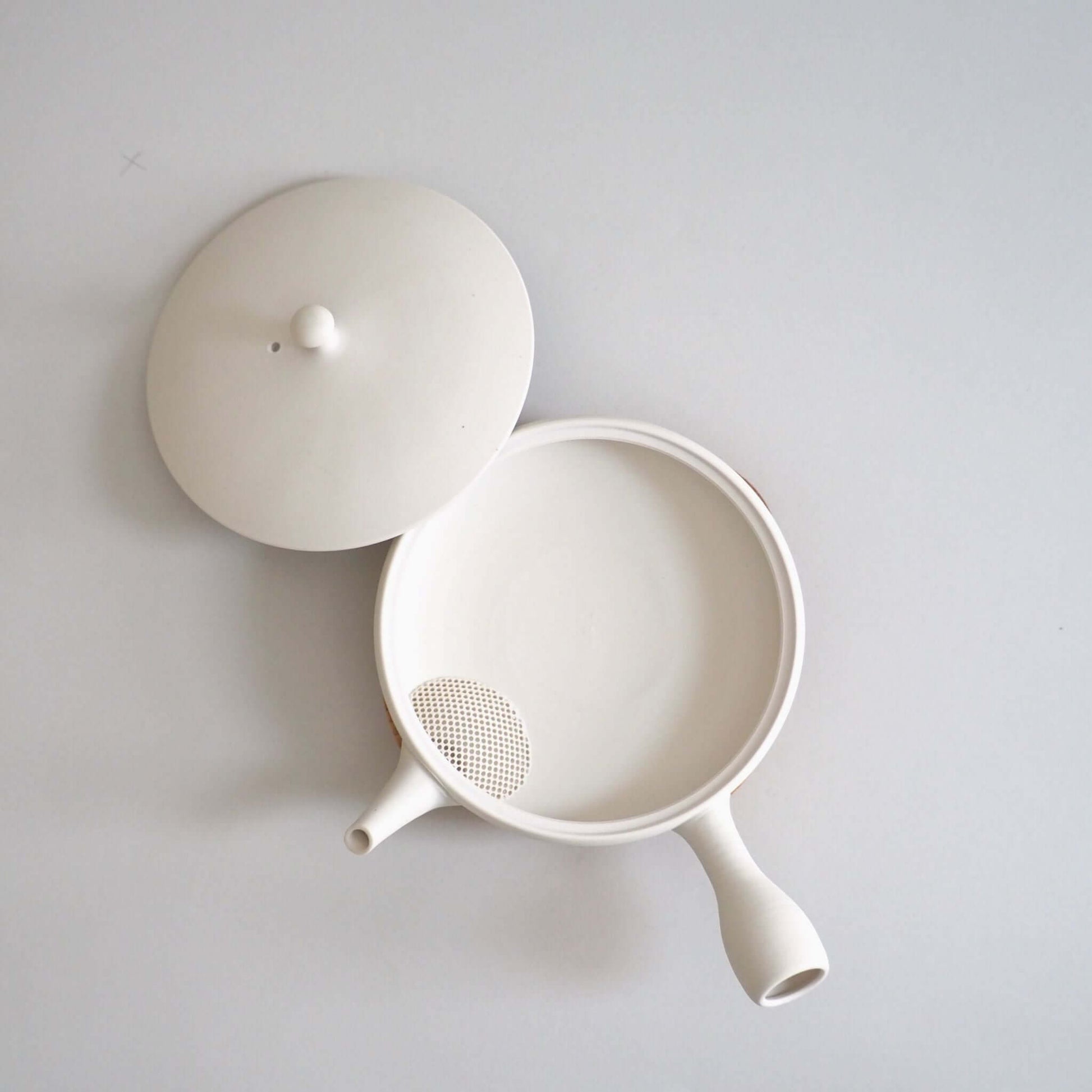 Tokoname ware white flat teapot, viewed from above — soft white appearance achieved through wheel-throwing.